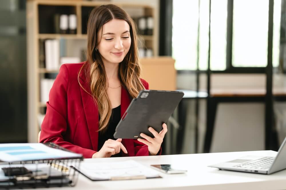 HR manager reviewing remote payroll assistant profiles from payroll recruitment agencies.
