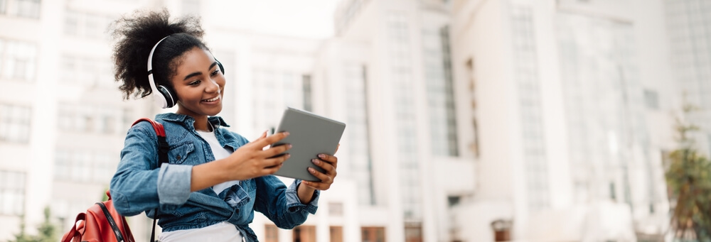 student smiling and attending her online classes