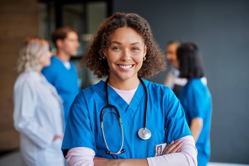 Psychiatric Mental Health Nurse Practitioner standing and smiling 