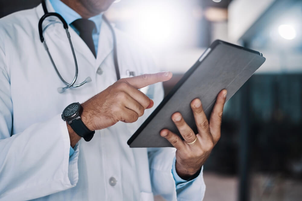 virtual medical sheduler working remotely with his tablet