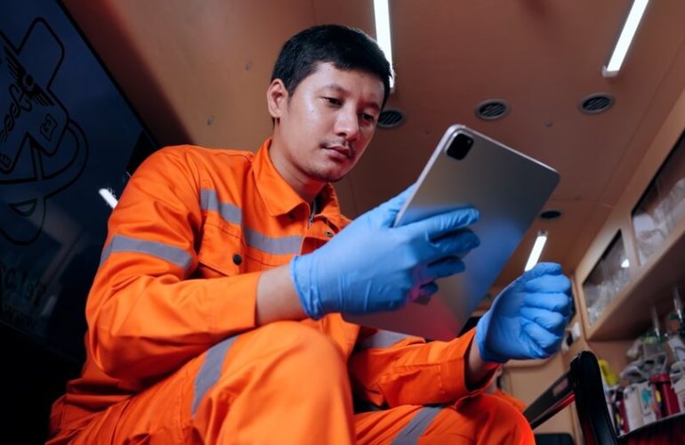 Patient Care Technician working remotely through his mobile