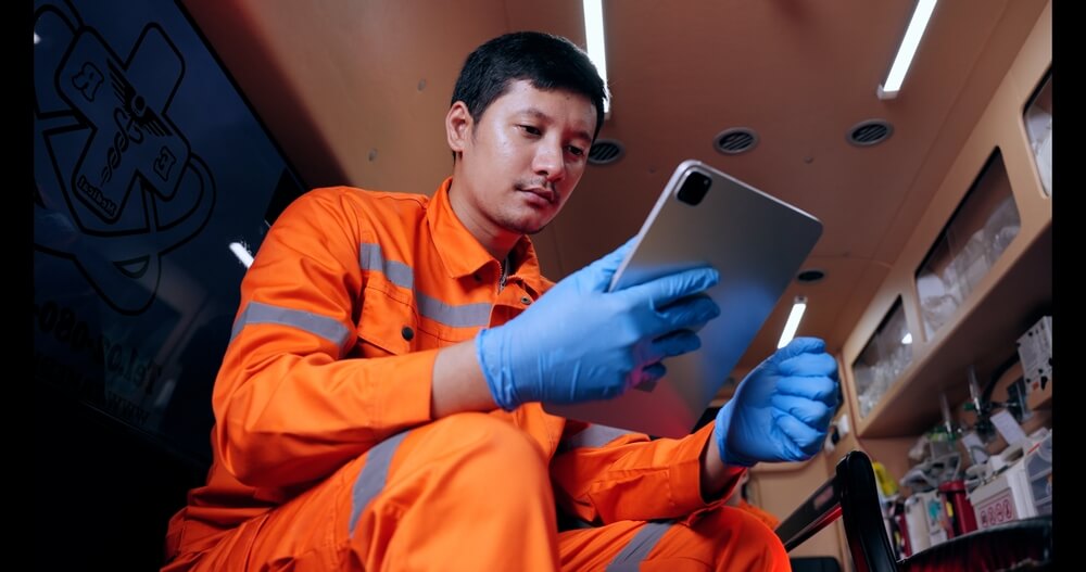 Patient Care Technician working remotely through his mobile