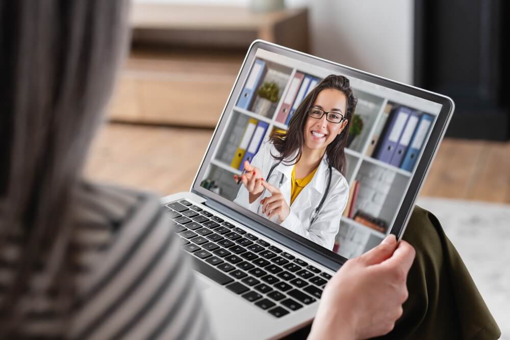 Psychiatric Mental Health Nurse Practitioner smiling and following up with a patient