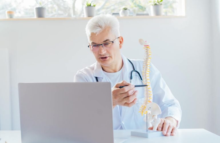Chiropractic Assistant describing parts of human spinal cord virtually