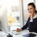 Professional virtual legal assistant handling legal documents and client communication using a laptop remotely.