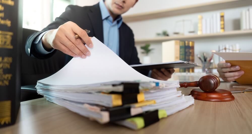 ttorneys managing court documents, emails, and administrative tasks in a busy law office.