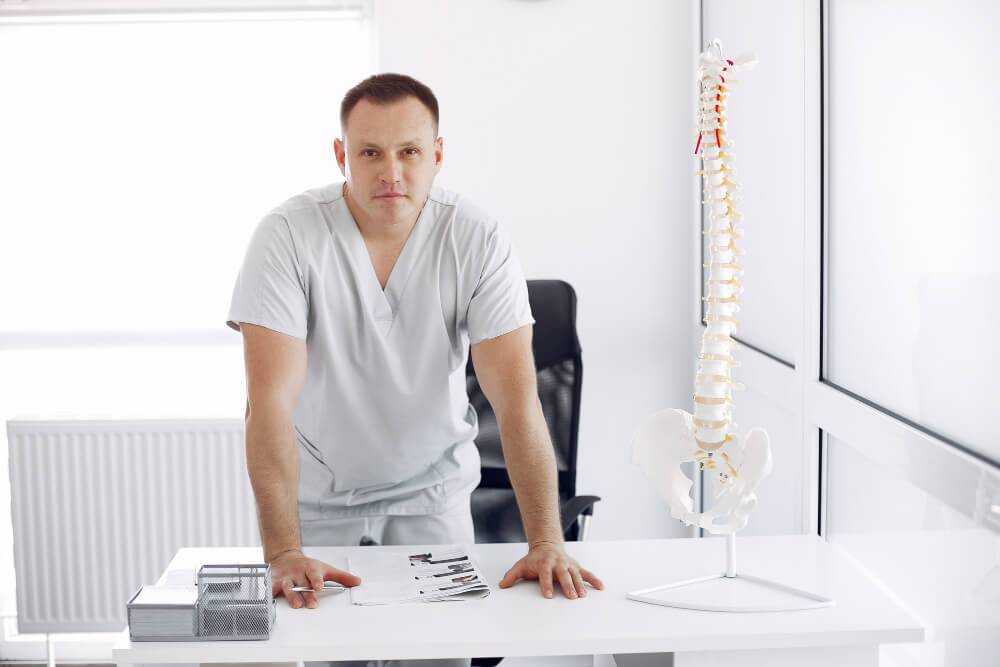 Chiropractor managing paperwork and documentation instead of focusing on patient care