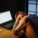 Remote worker feeling stressed and overwhelmed while working from home showing signs of burnout