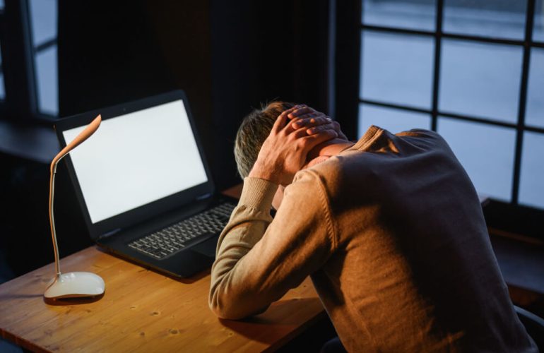 Remote worker feeling stressed and overwhelmed while working from home showing signs of burnout