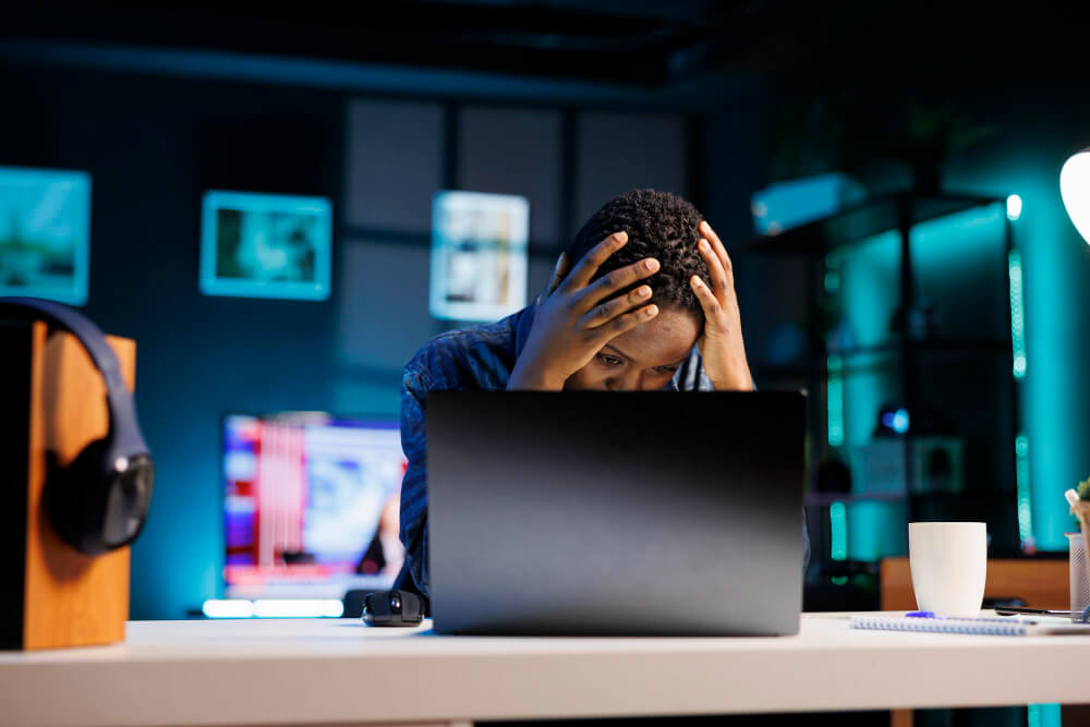 Remote worker feeling stressed and overwhelmed while working from home showing signs of burnout