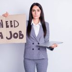 Job seeker holding a poster NEED A JOB. desperate and sad