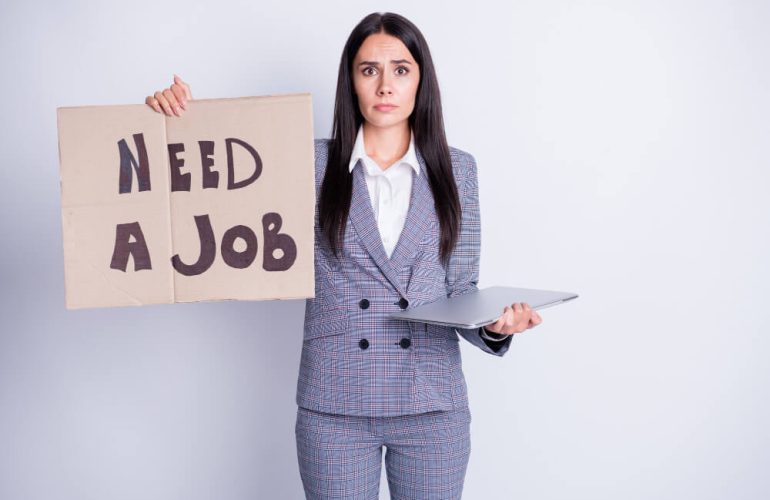 Job seeker holding a poster NEED A JOB. desperate and sad
