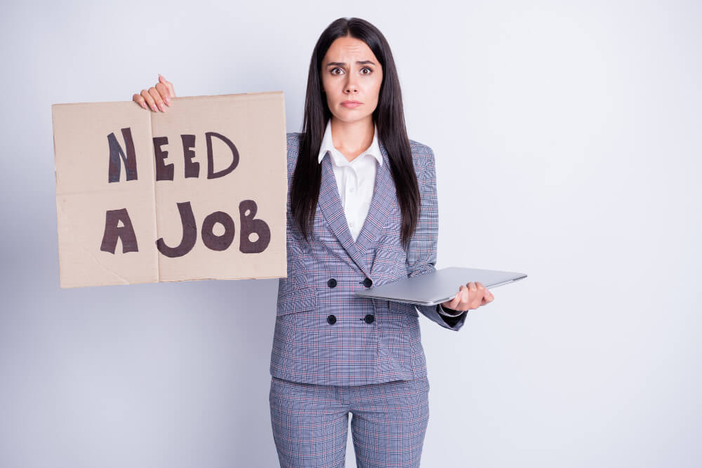 Job seeker holding a poster NEED A JOB. desperate and sad