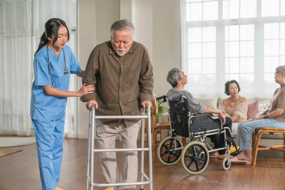 Professional nurse helping elderly at nursing home 