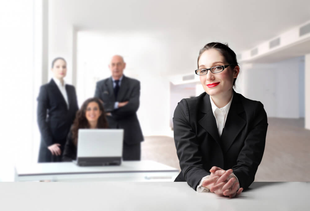 Lawyers working with legal assistants and paralegals in a collaborative law firm environment managing cases and documents