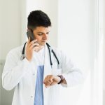 a doctor frustrated waiting for patient not appearing on schedule time
